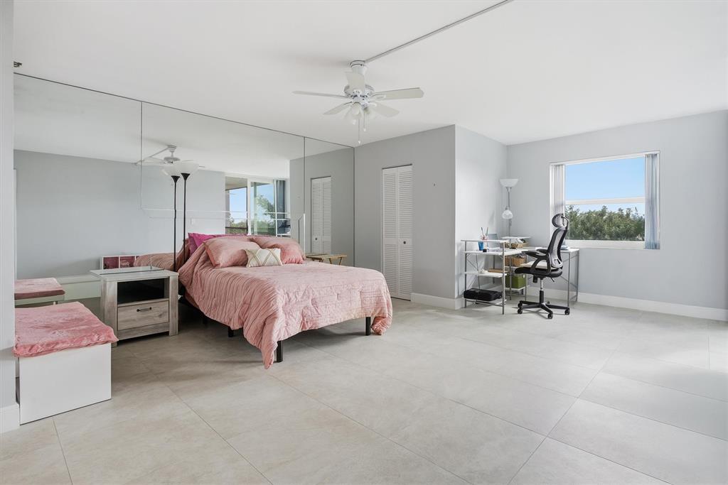 3910 Inverrary Boulevard, Unit 708B Lauderhill, FL 33319 - Photo 18 of 58 a spacious bedroom with a bed and a table chair