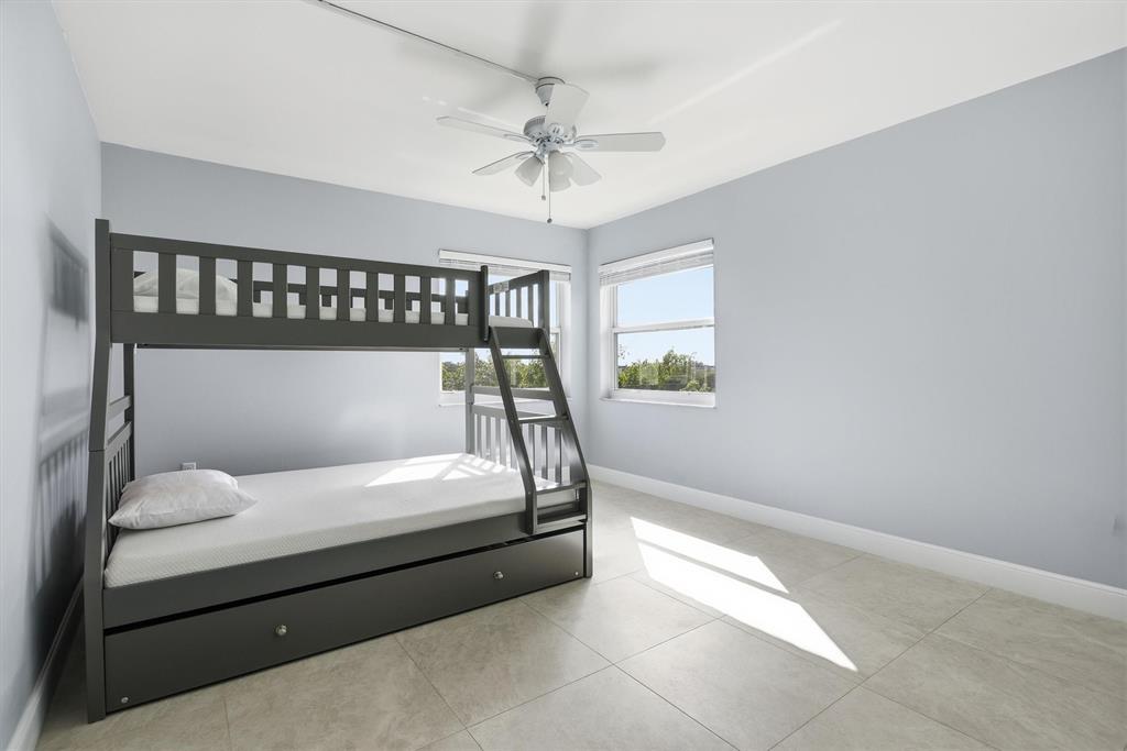 3910 Inverrary Boulevard, Unit 708B Lauderhill, FL 33319 - Photo 27 of 58 a bedroom with a bed and window