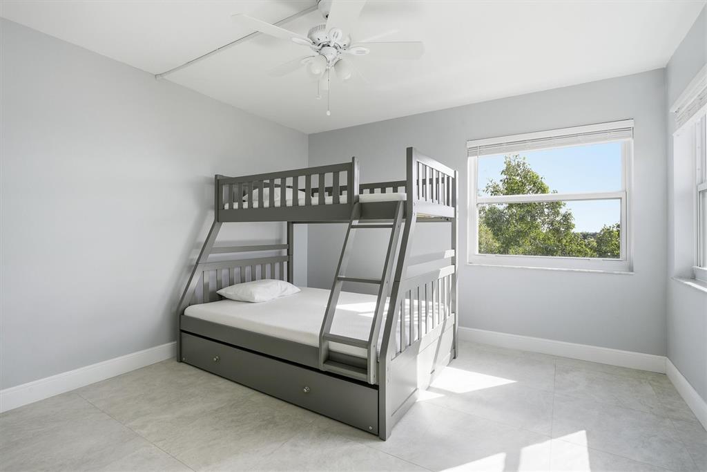 3910 Inverrary Boulevard, Unit 708B Lauderhill, FL 33319 - Photo 28 of 58 a bedroom with a bed and a window