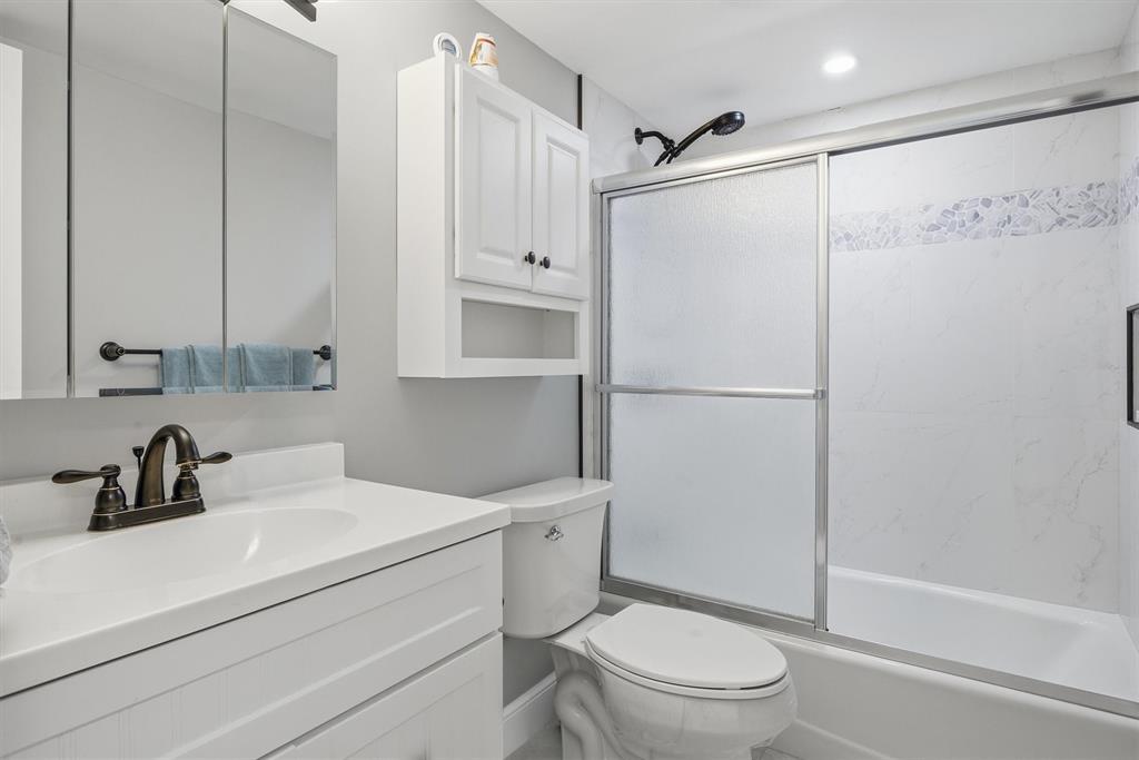 3910 Inverrary Boulevard, Unit 708B Lauderhill, FL 33319 - Photo 29 of 58 a bathroom with a sink a toilet and shower