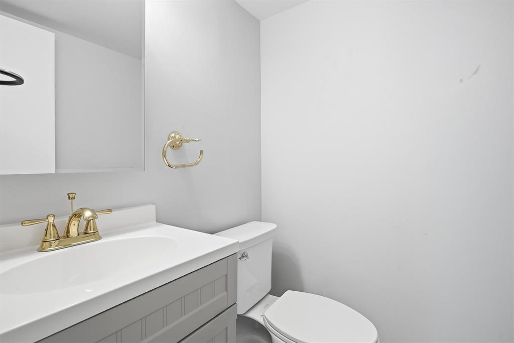 3910 Inverrary Boulevard, Unit 708B Lauderhill, FL 33319 - Photo 31 of 58 a bathroom with a granite countertop toilet and sink