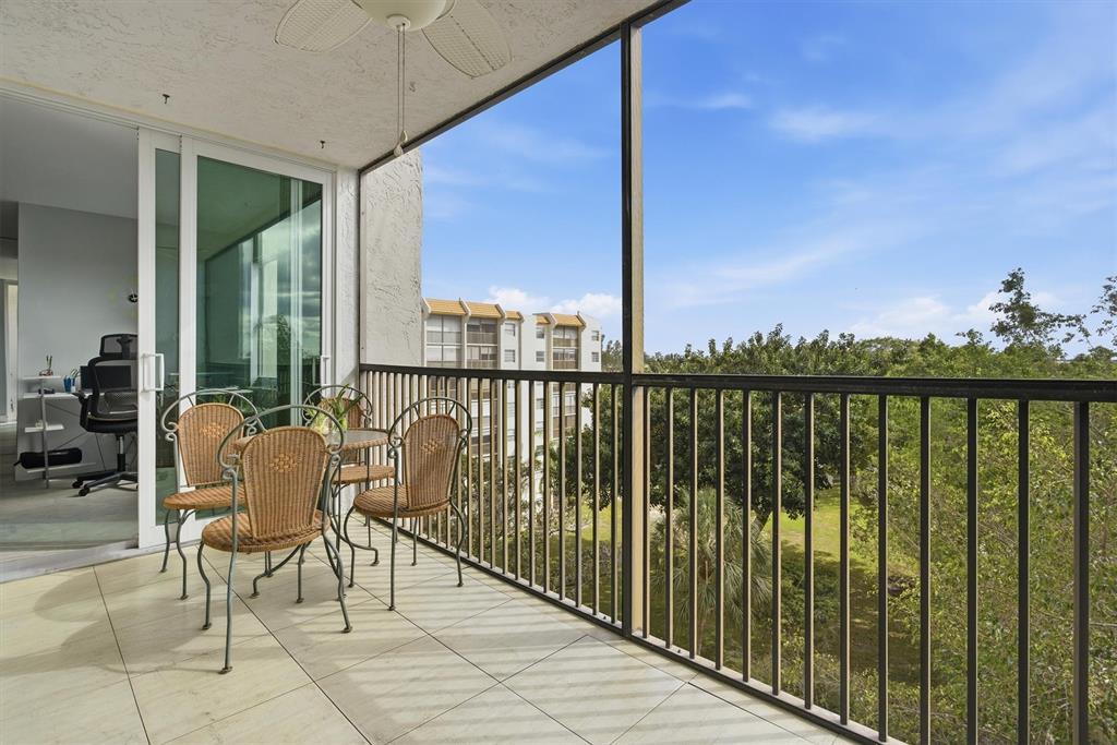 3910 Inverrary Boulevard, Unit 708B Lauderhill, FL 33319 - Photo 4 of 58 a balcony with furniture and city view