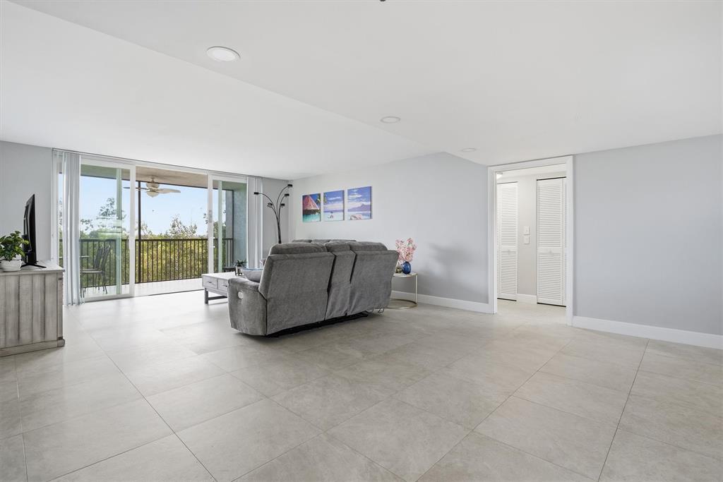 3910 Inverrary Boulevard, Unit 708B Lauderhill, FL 33319 - Photo 5 of 58 a spacious bedroom with a bed and large window