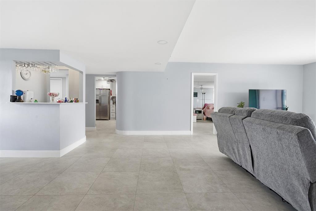 3910 Inverrary Boulevard, Unit 708B Lauderhill, FL 33319 - Photo 7 of 58 a living room with furniture and a wooden floor