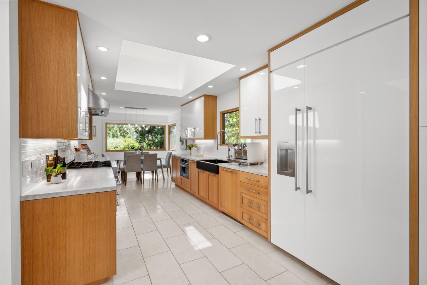 2201 Pullman Avenue Belmont, CA 94002 - Photo 11 of 48 a kitchen with stainless steel appliances kitchen island granite countertop dining table chairs and a refrigerator