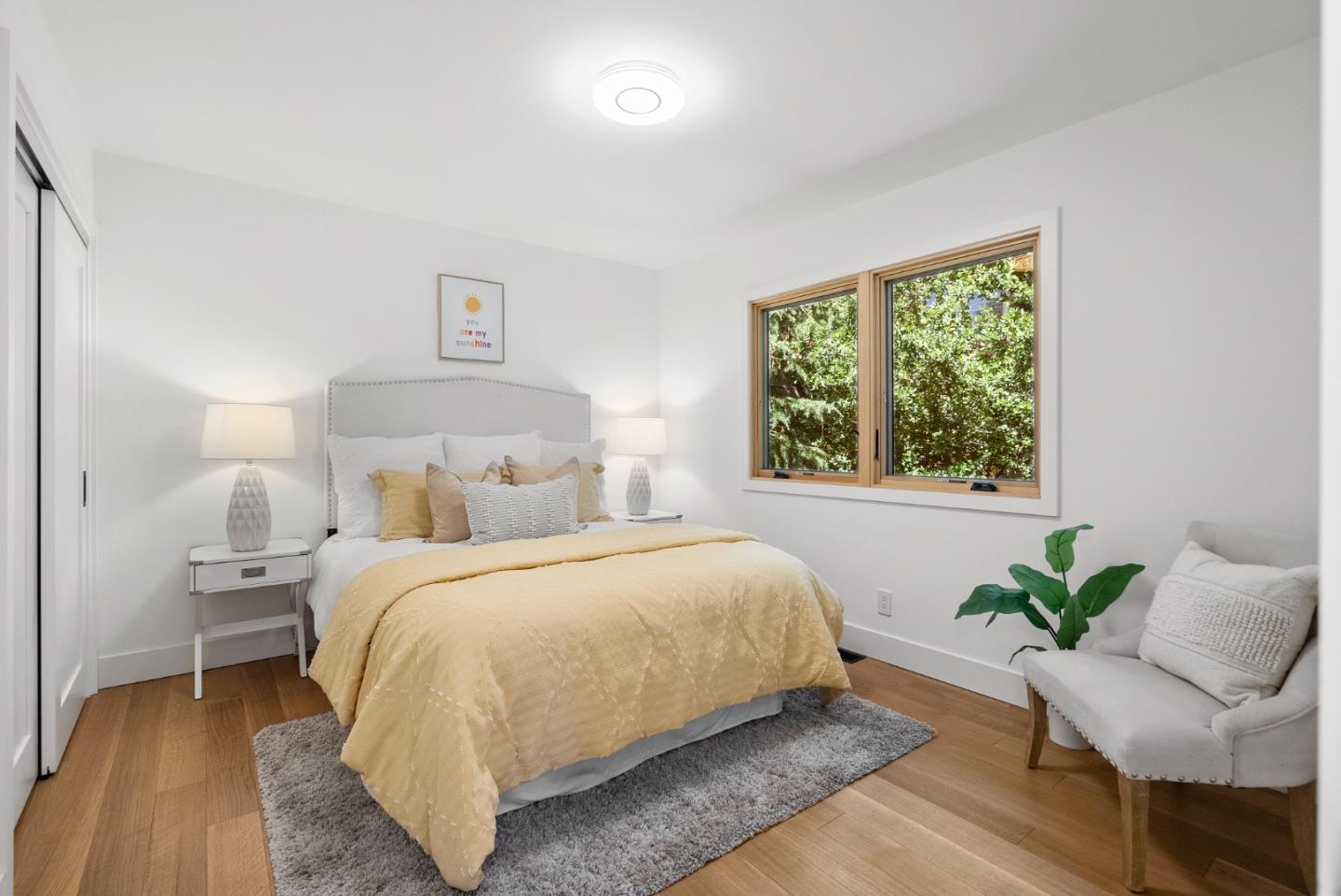 2201 Pullman Avenue Belmont, CA 94002 - Photo 15 of 48 a bedroom with a bed and a chair