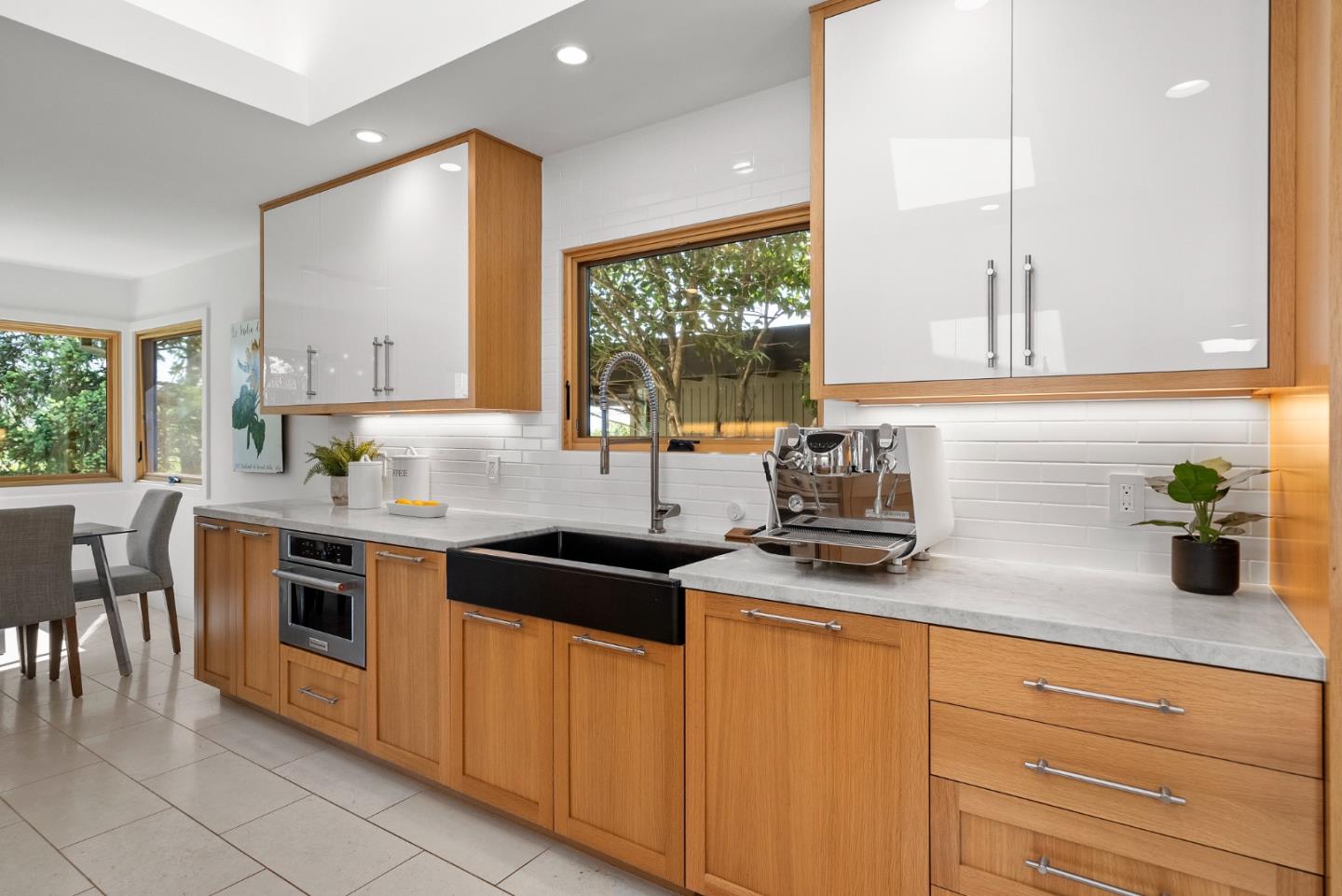 2201 Pullman Avenue Belmont, CA 94002 - Photo 9 of 48 a kitchen with stainless steel appliances granite countertop white cabinets a window a sink and a counter space