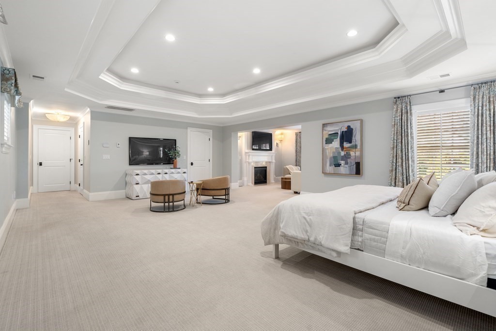 39 Temple Road Wellesley, MA 02482 - Photo 13 of 35 a bedroom with furniture and a flat screen tv