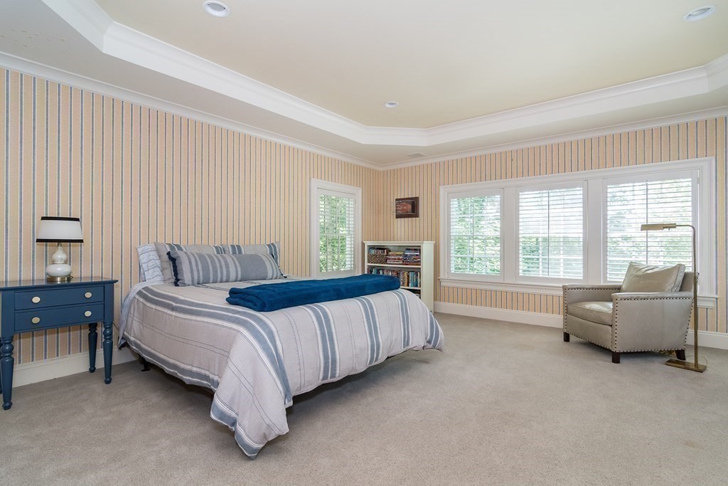 39 Temple Road Wellesley, MA 02482 - Photo 17 of 35 a bed room with a bed and a couch with outer view