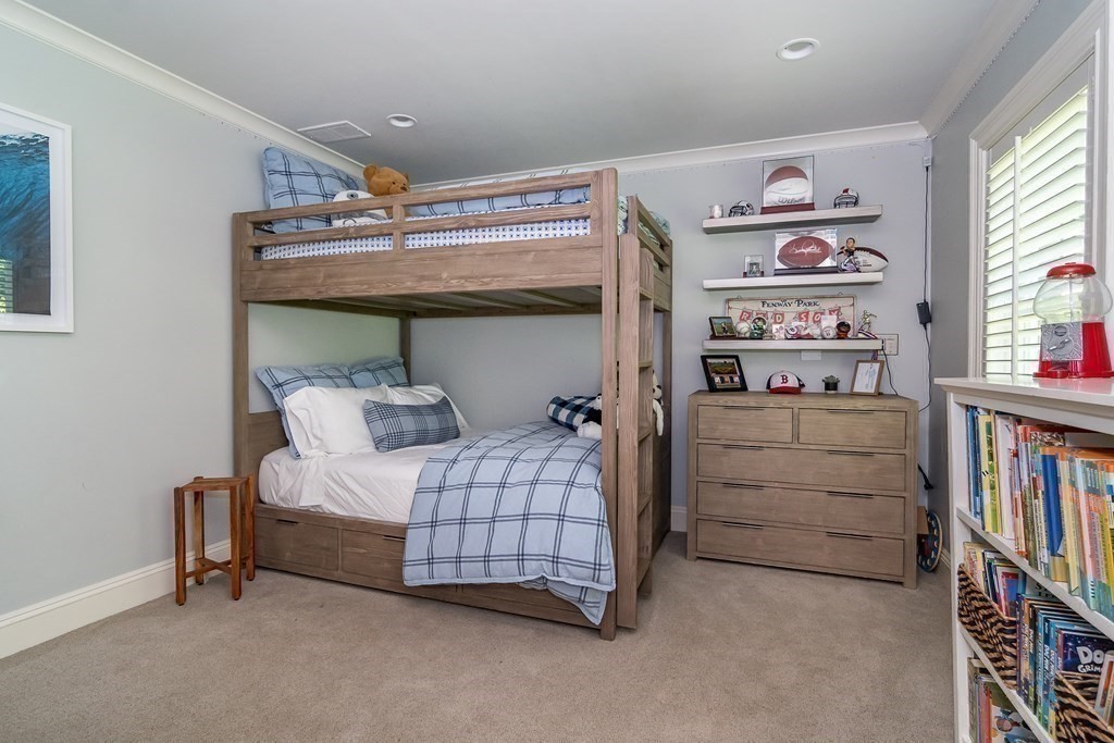 39 Temple Road Wellesley, MA 02482 - Photo 18 of 35 a bedroom with a bed and a book shelf