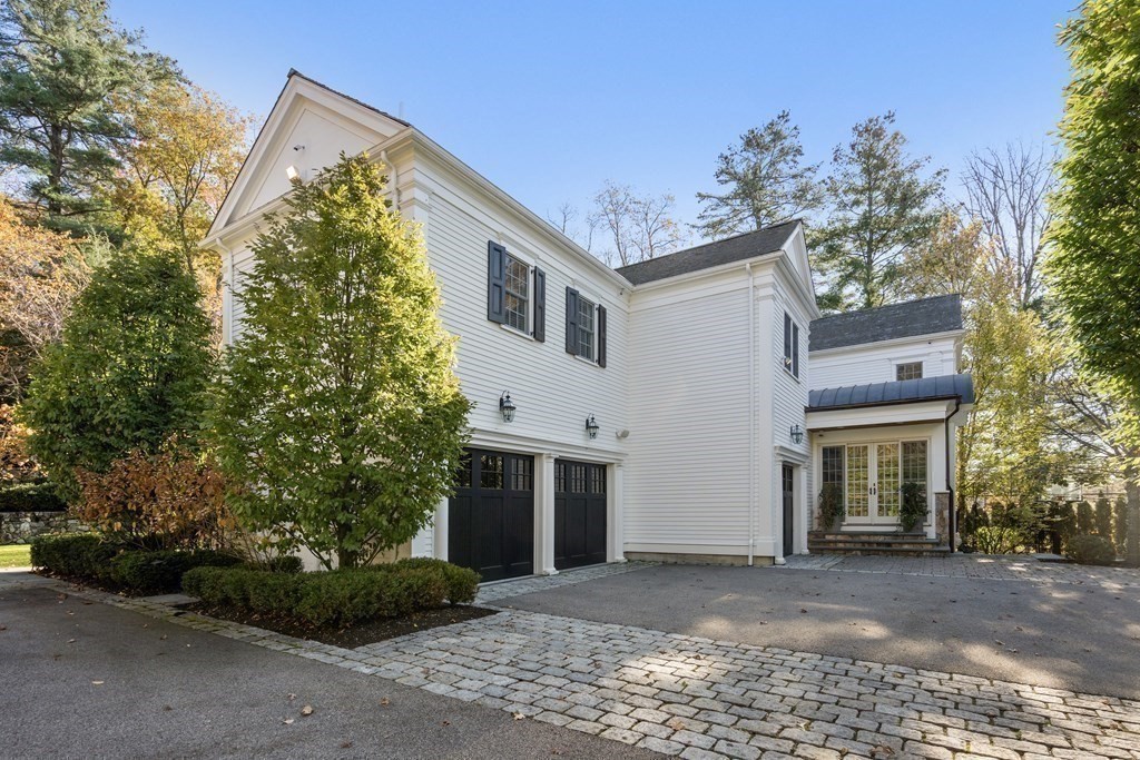 39 Temple Road Wellesley, MA 02482 - Photo 30 of 35 a front view of a house with a yard and garage