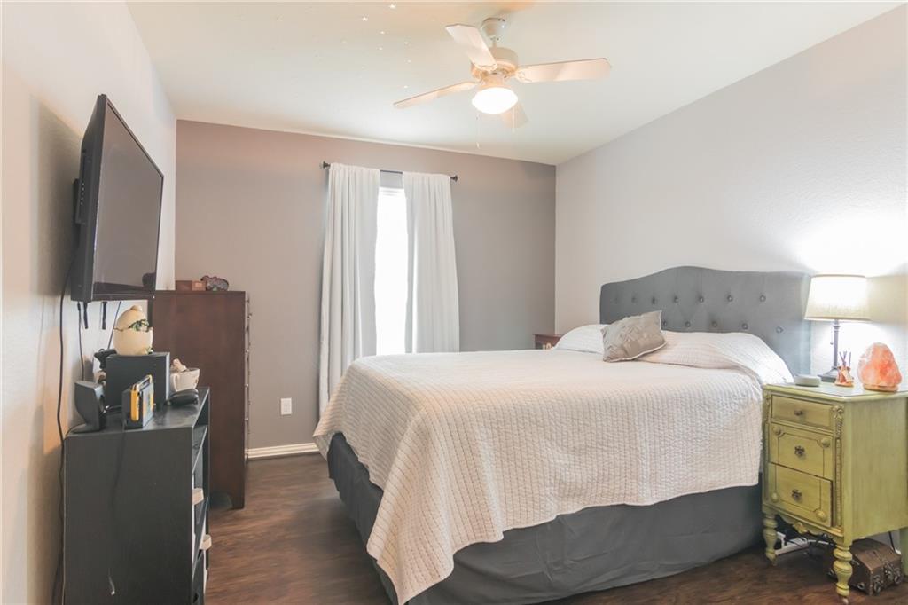 252 Pond View Pass Buda, TX 78610 - Photo 24 of 37 Bedroom with dark wood-type flooring and ceiling fan
