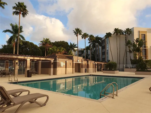 a view of a swimming pool with a patio and a yard