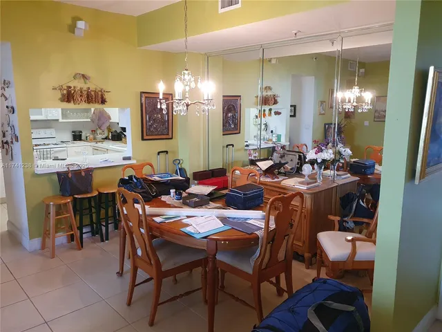 a living room with furniture a flat screen tv and a floor to ceiling window