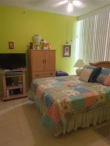 a room with a bed and a television