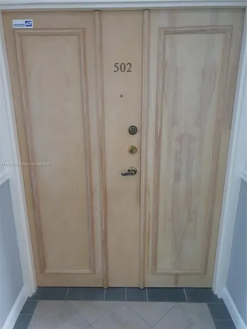 a kitchen with stainless steel appliances a refrigerator and a stove top oven