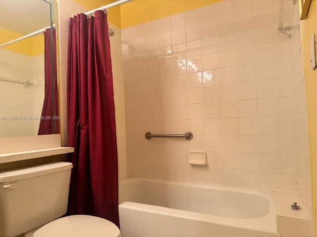 a kitchen with granite countertop a refrigerator and a stove top oven