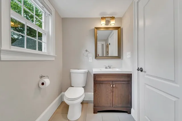 a bathroom with a toilet a sink and a mirror