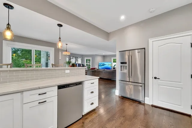a kitchen with refrigerator and window