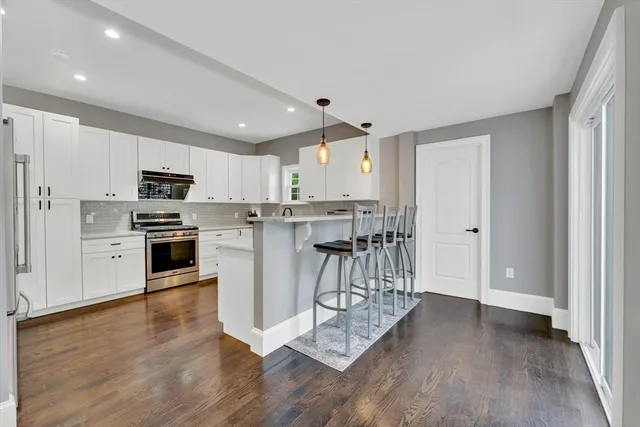 a kitchen with stainless steel appliances a refrigerator and a stove top oven