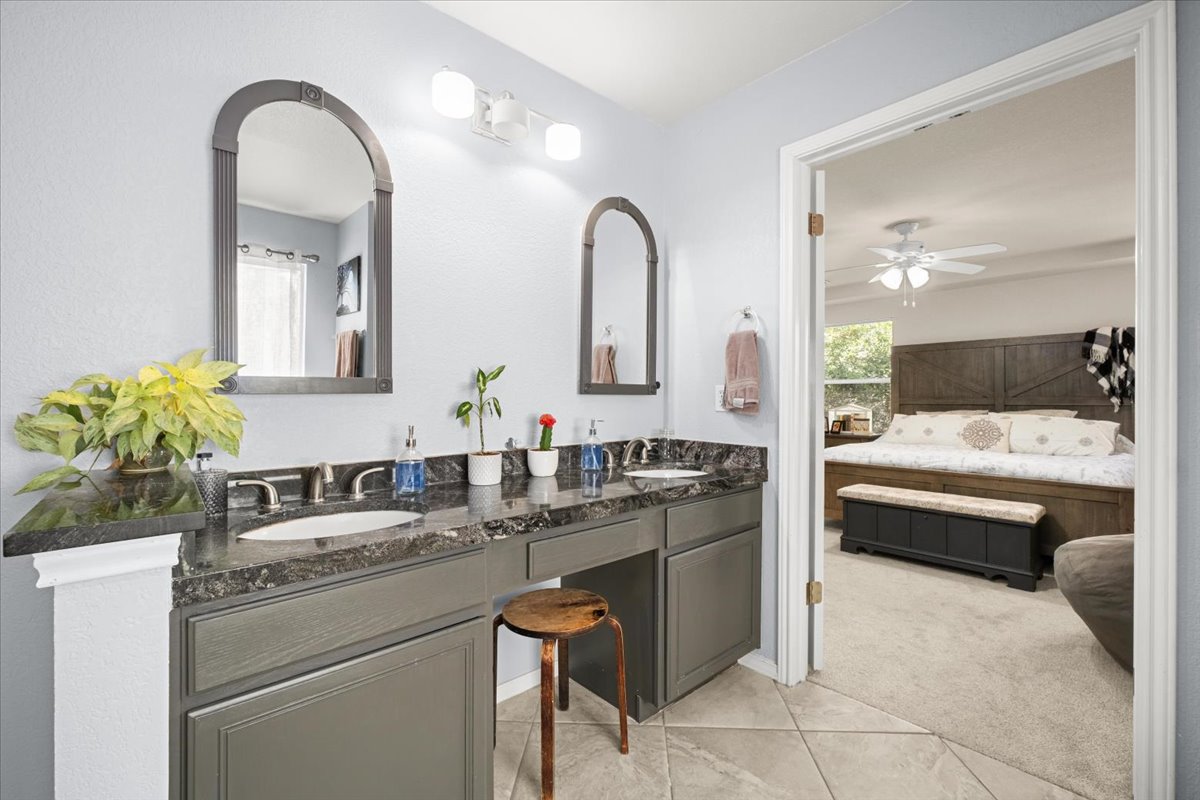 455 Logan Road Georgetown, TX 78628 - Photo 19 of 35 a bathroom with a double vanity sink and mirror