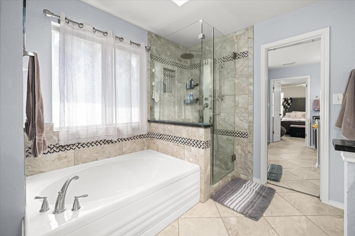 455 Logan Road Georgetown, TX 78628 - Photo 20 of 35 a bathroom with a bathtub and a shower