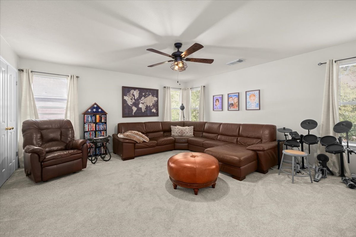 455 Logan Road Georgetown, TX 78628 - Photo 21 of 35 a living room with furniture a ceiling fan and a window