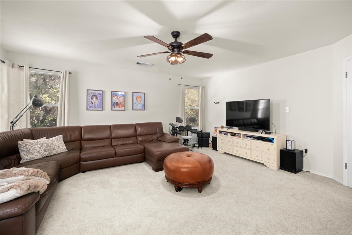 455 Logan Road Georgetown, TX 78628 - Photo 22 of 35 a living room with furniture and a flat screen tv