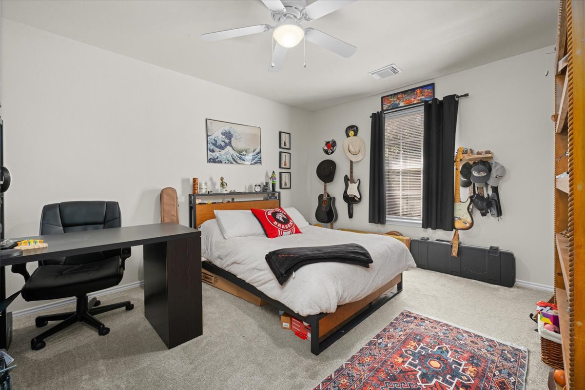 455 Logan Road Georgetown, TX 78628 - Photo 23 of 35 a bed room with a bed and a desk