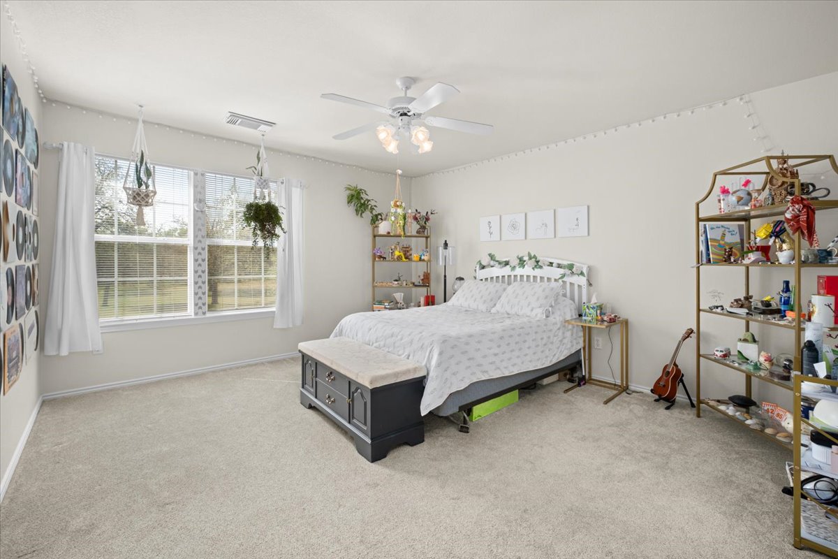 455 Logan Road Georgetown, TX 78628 - Photo 24 of 35 a bedroom with a bed and a large window