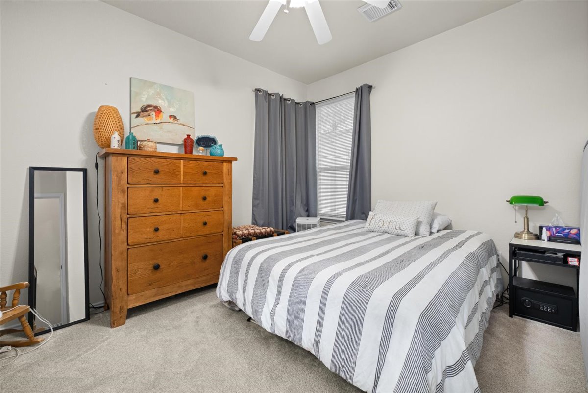 455 Logan Road Georgetown, TX 78628 - Photo 25 of 35 a bedroom with a bed and a dresser