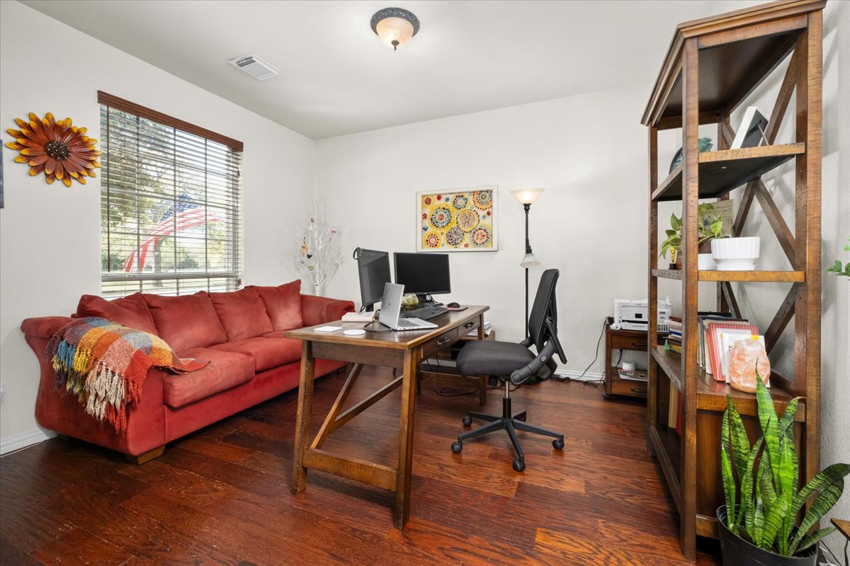 455 Logan Road Georgetown, TX 78628 - Photo 26 of 35 a living room with furniture a window and wooden floor