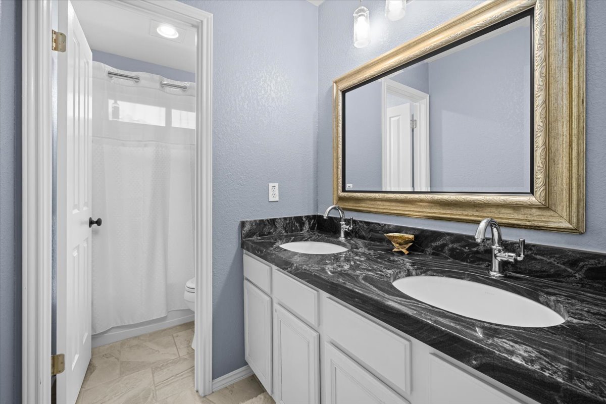 455 Logan Road Georgetown, TX 78628 - Photo 27 of 35 a bathroom with a sink and a mirror