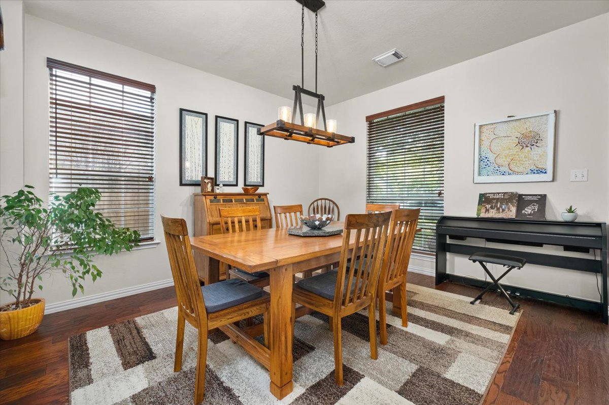 455 Logan Road Georgetown, TX 78628 - Photo 4 of 35 a view of a dining room with furniture window and wooden floor
