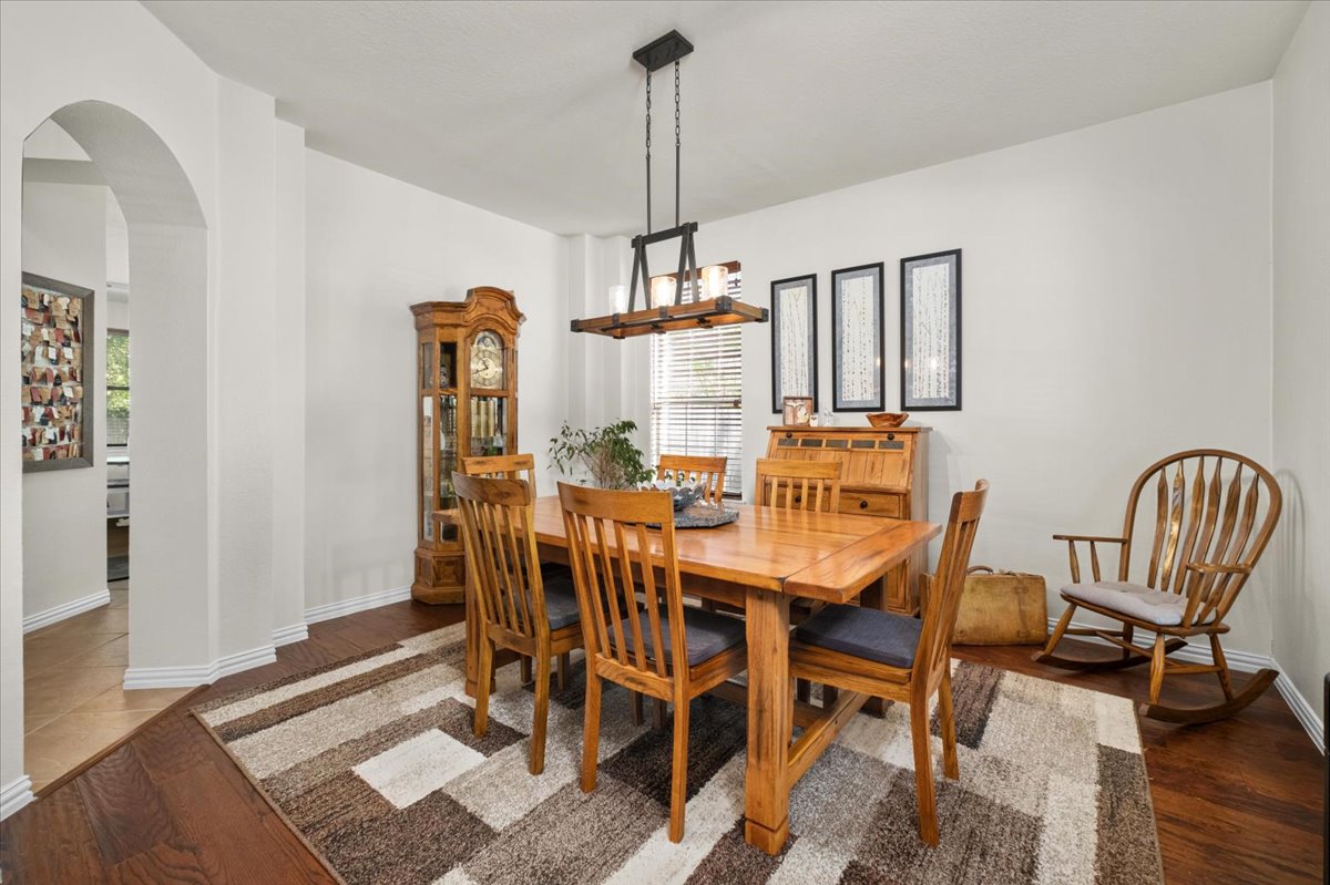 455 Logan Road Georgetown, TX 78628 - Photo 5 of 35 a view of a dining room with furniture and wooden floor