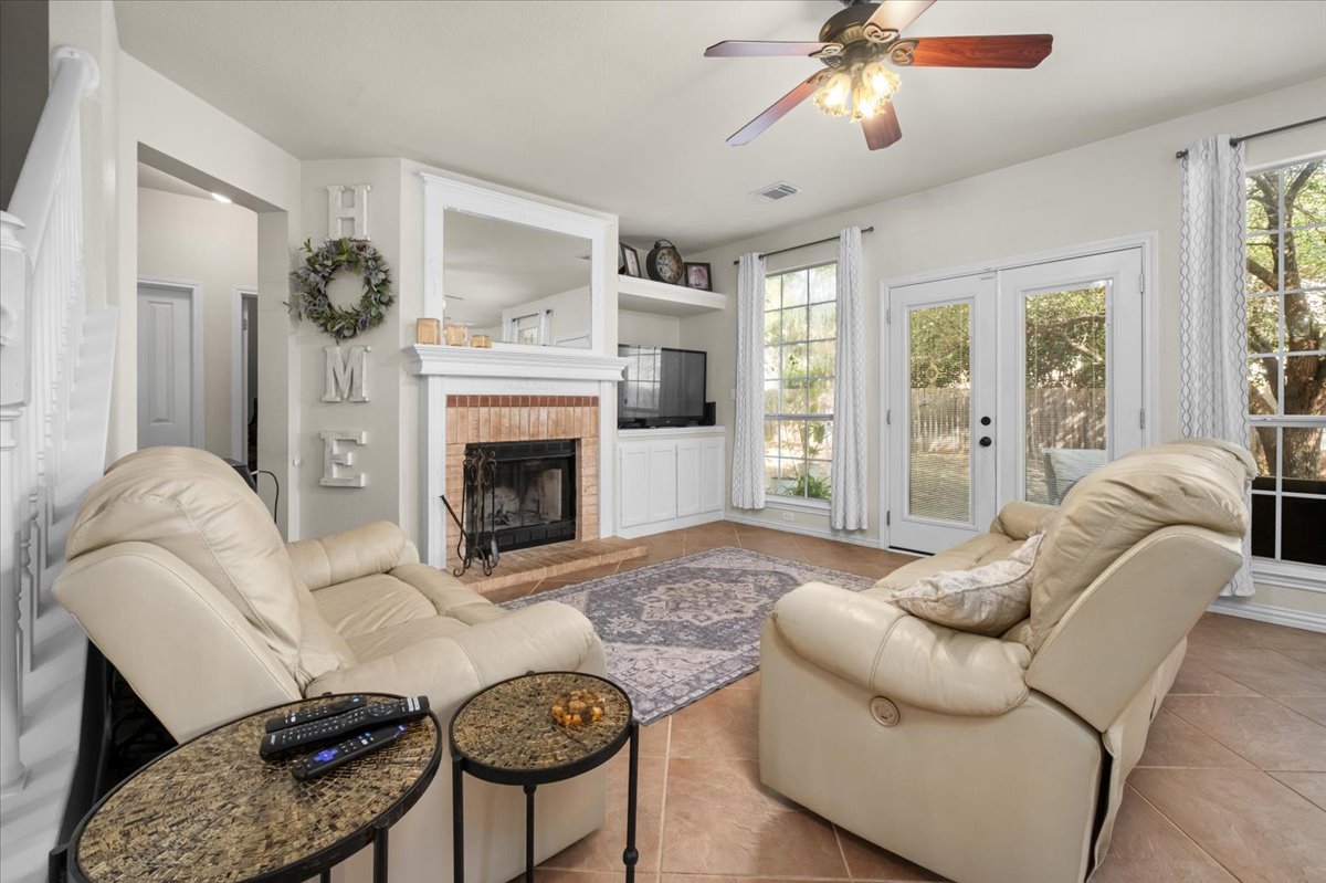 455 Logan Road Georgetown, TX 78628 - Photo 9 of 35 a living room with furniture a window and a fireplace