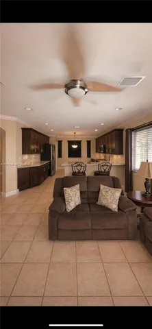 a living room with furniture a flat screen tv and a table