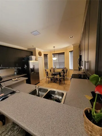 a view of a livingroom with a ceiling fan and window