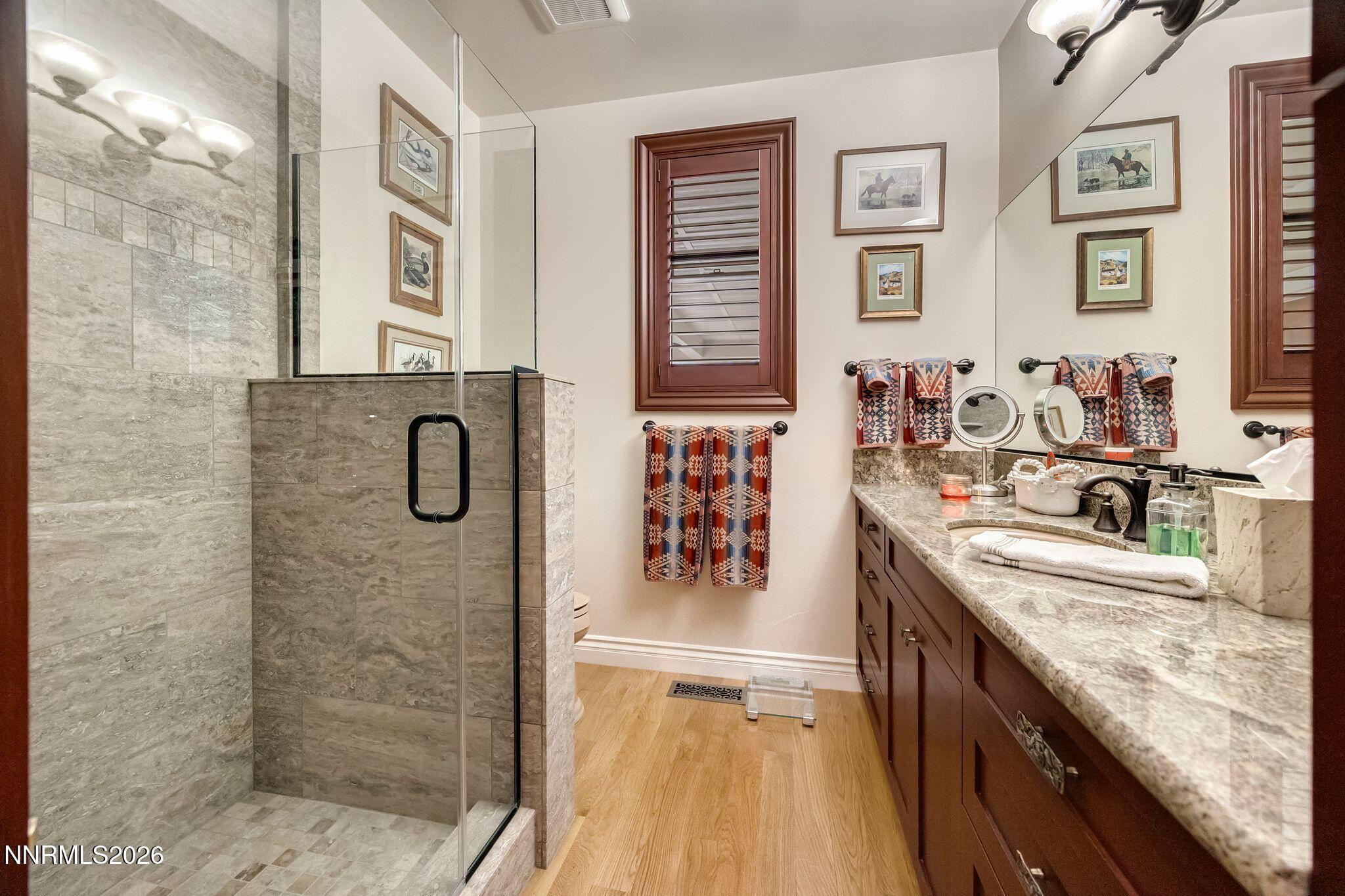 250 Jacks Valley Ranch Road Carson City, NV 89705 - Photo 21 of 44 a bathroom with a granite countertop sink a mirror and shower
