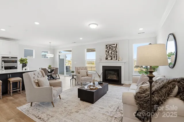 a living room with furniture fireplace and dining table