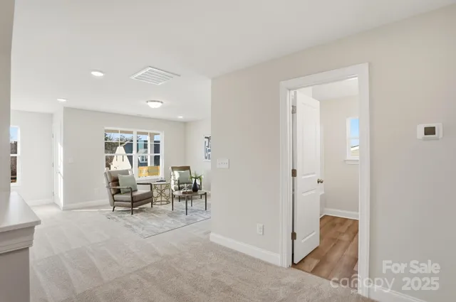 a living room with furniture and a chair