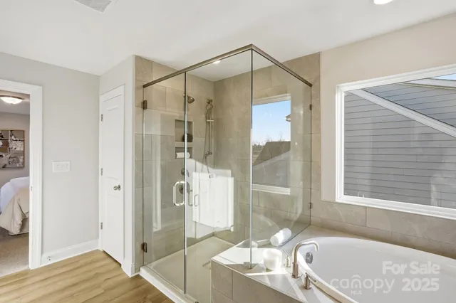 a bathroom with a tub shower and sink