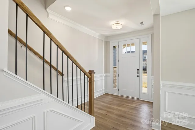 a view of an entryway with wooden floor