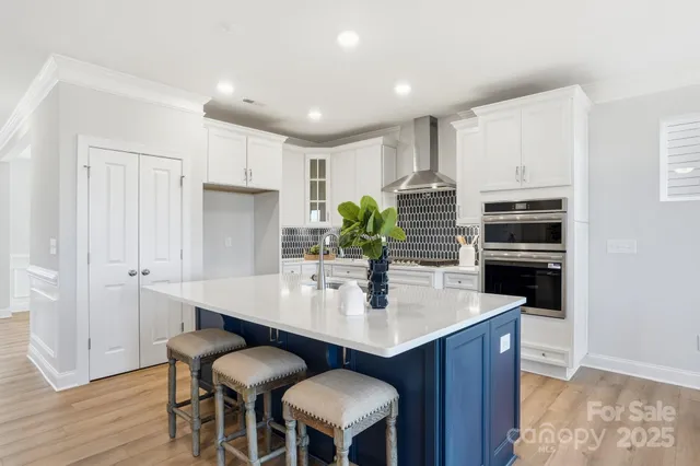 a kitchen with a table chairs sink and cabinets