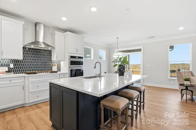 a large kitchen with a table chairs and a refrigerator
