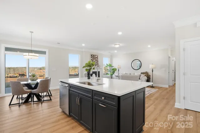 a large kitchen with a table and chairs