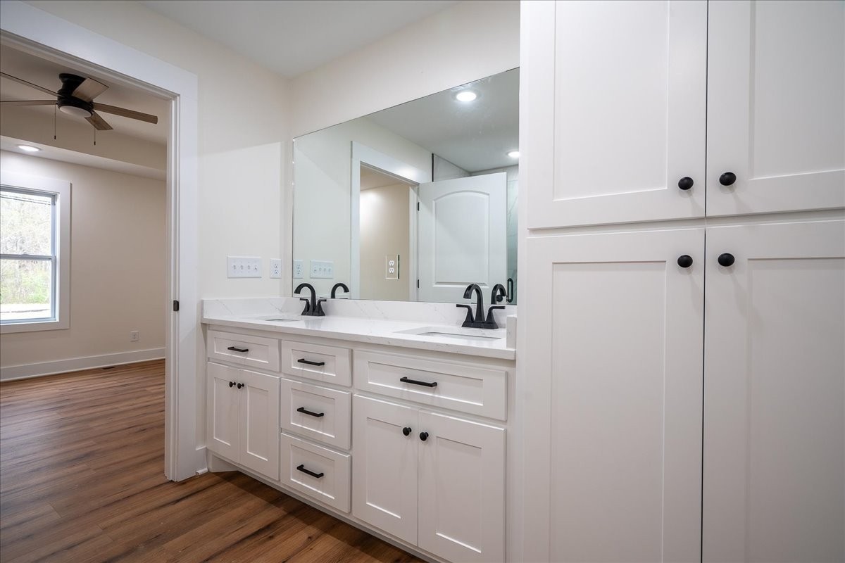 3987 Buffalo Road Summertown, TN 38483 - Photo 22 of 26 a bathroom with a double vanity sink and mirror