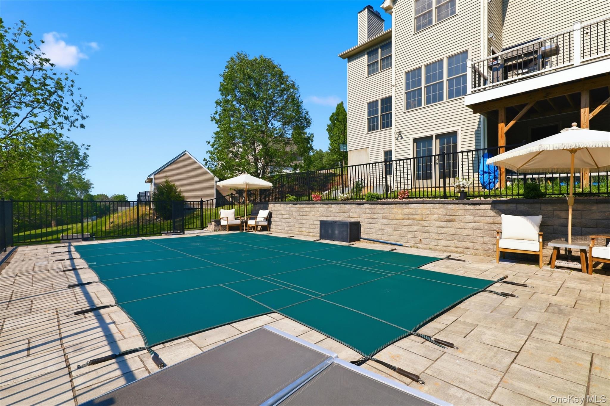 233 Devon Farms Road Stormville, NY 12582 - Photo 41 of 48 a view of a patio with a table and chairs under an umbrella
