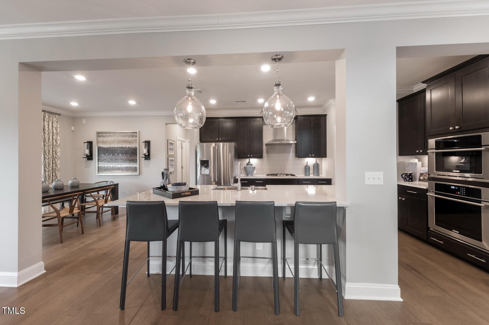 35 Stoddard Lane Garner, NC 27529 - Photo 11 of 38 a kitchen with stainless steel appliances kitchen island granite countertop a table chairs sink and cabinets