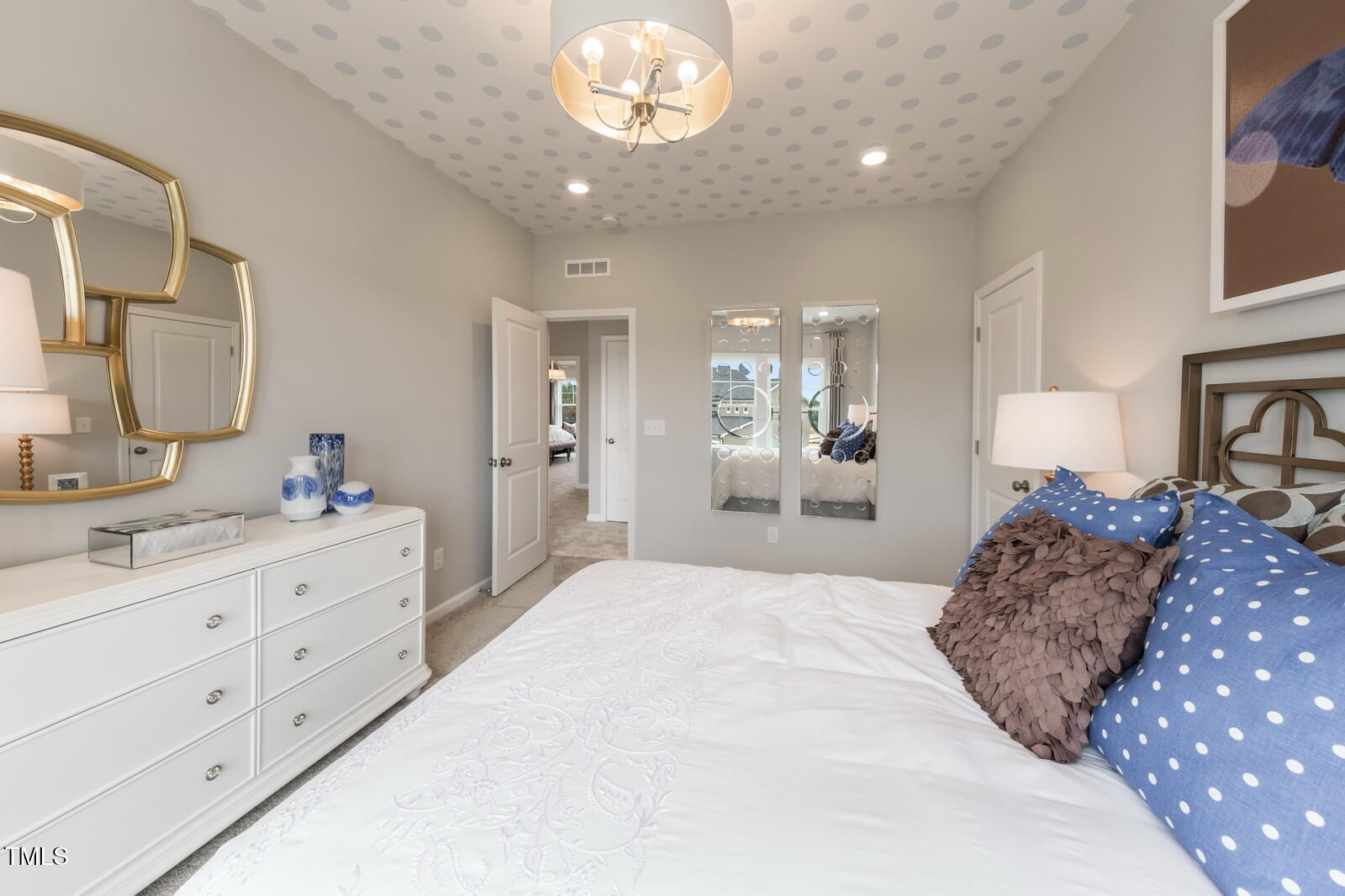 35 Stoddard Lane Garner, NC 27529 - Photo 26 of 38 a spacious bedroom with a large bed and a large mirror